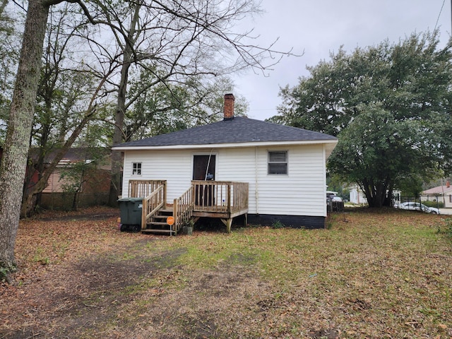 219 S Guignard Dr, Sumter, SC 29150 - back of property featuring a chimney, fence, a deck, and a shingled roof
