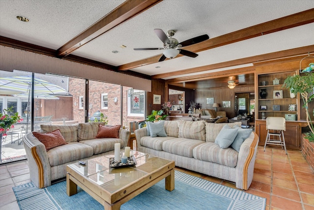 804 Camellia Rd, Augusta, GA 30909 - living area featuring a textured ceiling, beamed ceiling, wooden walls, plenty of natural light, and ceiling fan