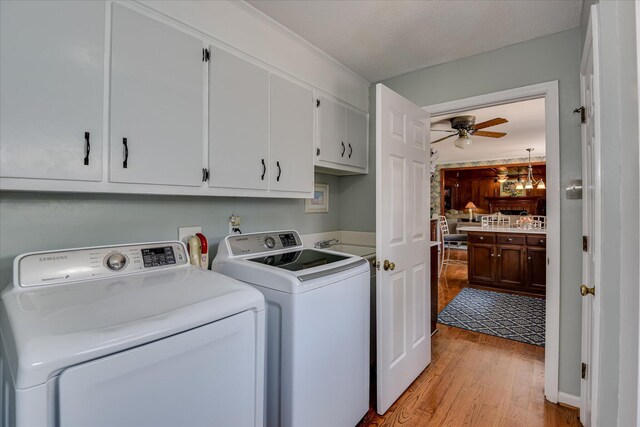804 Camellia Rd, Augusta, GA 30909 - laundry room with cabinet space, washer and dryer, light wood-type flooring, and ceiling fan