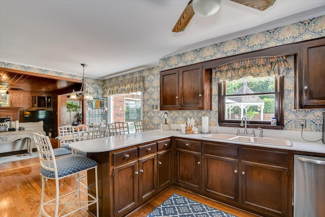 804 Camellia Rd, Augusta, GA 30909 - kitchen featuring wallpapered walls, light countertops, a peninsula, dishwasher, and light wood finished floors