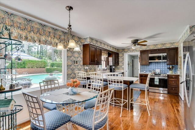 804 Camellia Rd, Augusta, GA 30909 - dining room with light wood-style floors, a ceiling fan, and wallpapered walls