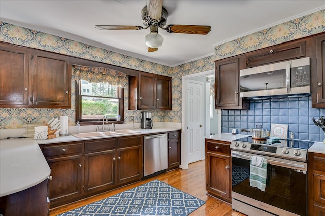 804 Camellia Rd, Augusta, GA 30909 - kitchen with appliances with stainless steel finishes, light countertops, ceiling fan, light wood-style flooring, and tasteful backsplash