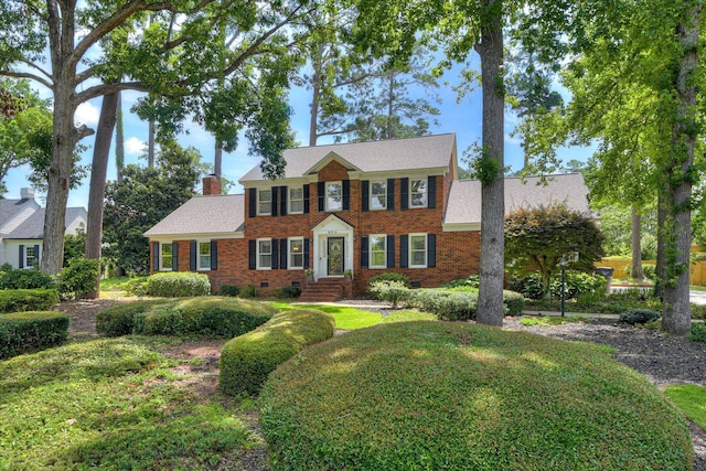 804 Camellia Rd, Augusta, GA 30909 - view of front facade with brick siding, a chimney, crawl space, and roof with shingles