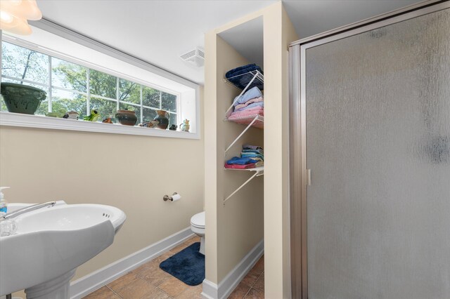 104 Sim St, Washington, GA 30673 - bathroom with a shower stall, toilet, baseboards, and a sink