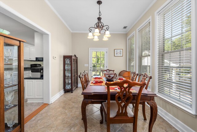 104 Sim St, Washington, GA 30673 - dining space featuring a chandelier, ornamental molding, baseboards, and light tile patterned floors
