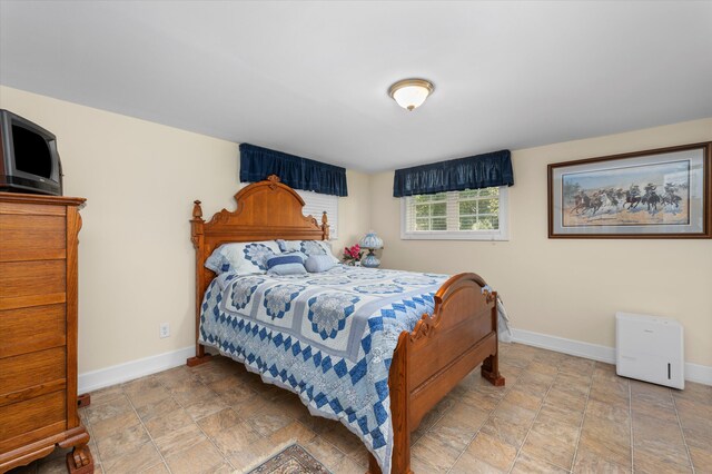 104 Sim St, Washington, GA 30673 - bedroom with baseboards and stone finish flooring