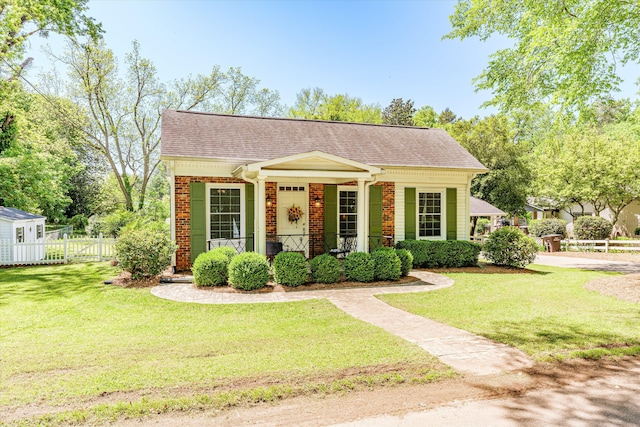 104 Sim St, Washington, GA 30673 - view of front of home featuring a shingled roof, brick siding, and a porch