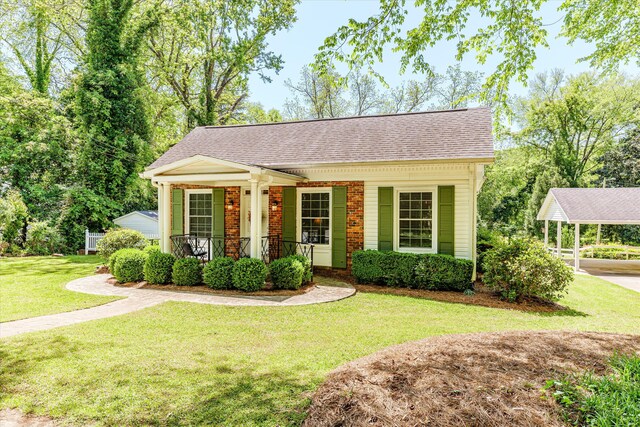104 Sim St, Washington, GA 30673 - view of front of house featuring roof with shingles, a porch, a front lawn, brick siding, and a carport
