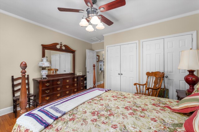 104 Sim St, Washington, GA 30673 - bedroom with multiple closets, wood finished floors, crown molding, baseboards, and a ceiling fan
