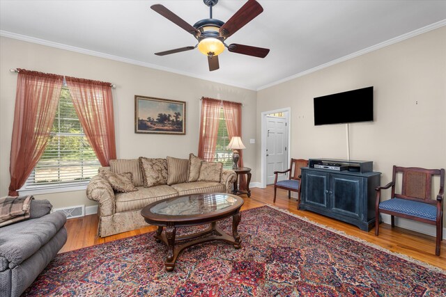 104 Sim St, Washington, GA 30673 - living room with crown molding, healthy amount of natural light, ceiling fan, and wood finished floors