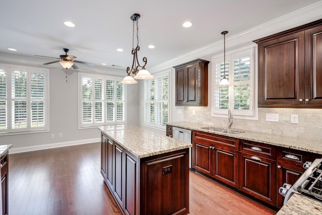 216 Dixon Ct, Evans, GA 30809 - kitchen featuring ceiling fan, ornamental molding, tasteful backsplash, gas range, and a kitchen island