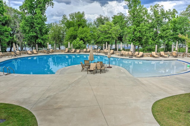 216 Dixon Ct, Evans, GA 30809 - community pool featuring a patio and view of wooded area