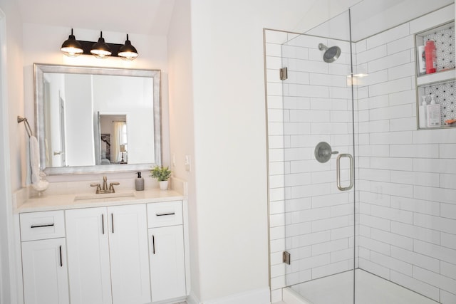 full bath with a stall shower and vanity