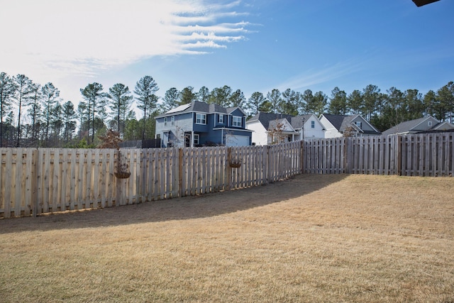 view of yard featuring a residential view and a fenced backyard