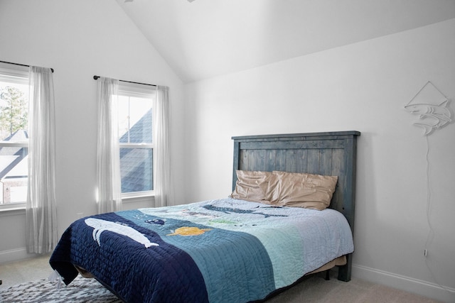 bedroom featuring carpet flooring, multiple windows, and vaulted ceiling