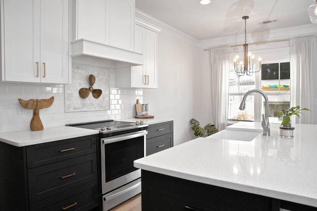 kitchen featuring dark cabinetry, stainless steel electric stove, ornamental molding, a sink, and white cabinets