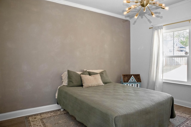 bedroom with baseboards, wood finished floors, and crown molding