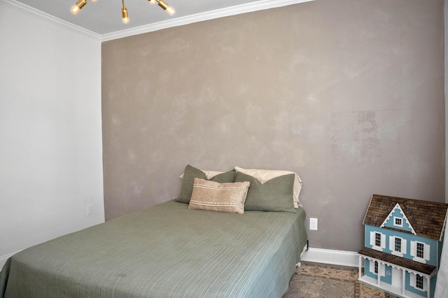 bedroom with an inviting chandelier and ornamental molding