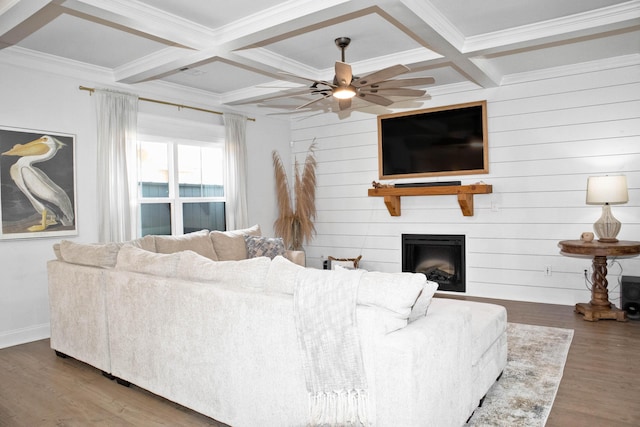 living room featuring ceiling fan, beam ceiling, a fireplace, wood finished floors, and coffered ceiling