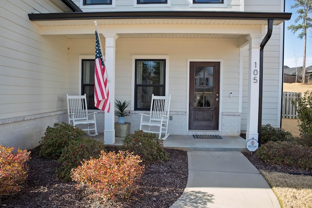 view of exterior entry with covered porch