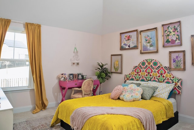 bedroom featuring multiple windows, carpet, and baseboards