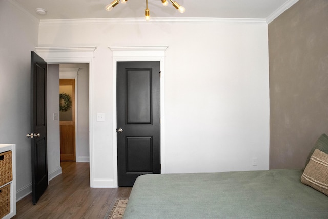 bedroom featuring crown molding, wood finished floors, and baseboards