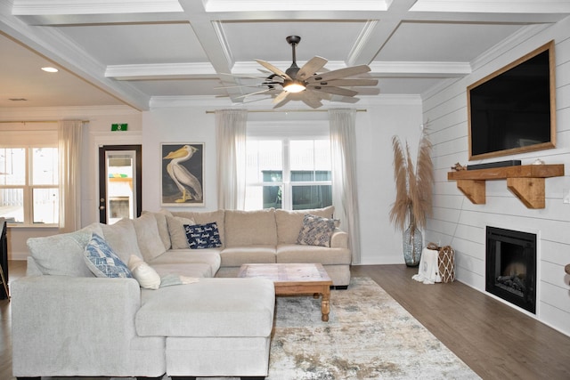 living room with a wealth of natural light, coffered ceiling, and a fireplace