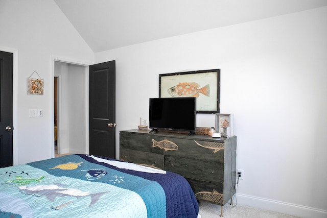 carpeted bedroom with baseboards and lofted ceiling