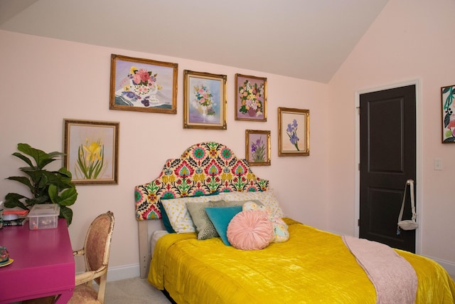 carpeted bedroom with lofted ceiling and baseboards