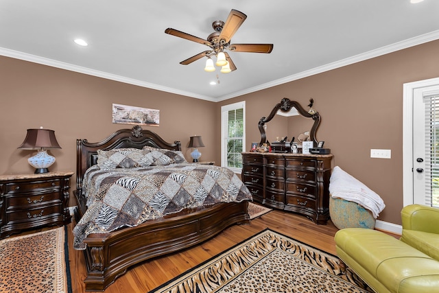 bedroom featuring hardwood / wood-style floors, ceiling fan, and ornamental molding