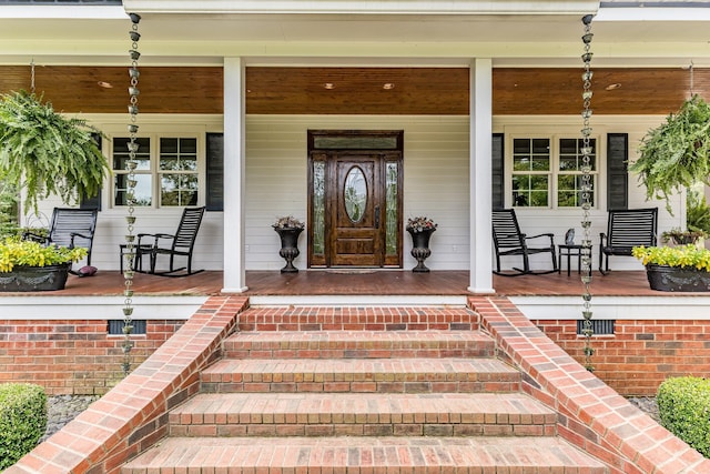 view of exterior entry featuring a porch