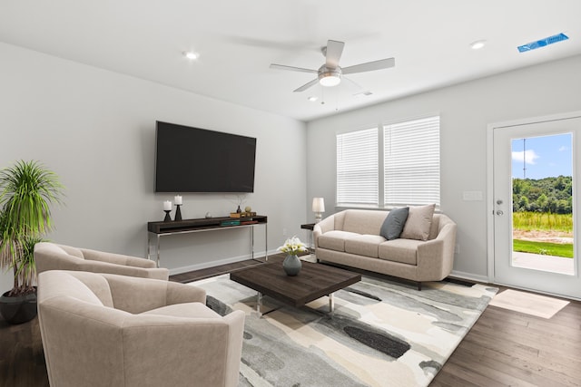 living room featuring ceiling fan and wood-type flooring