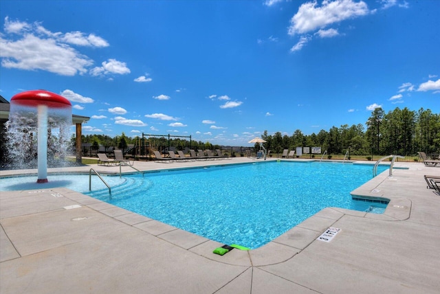 view of pool featuring pool water feature and a patio