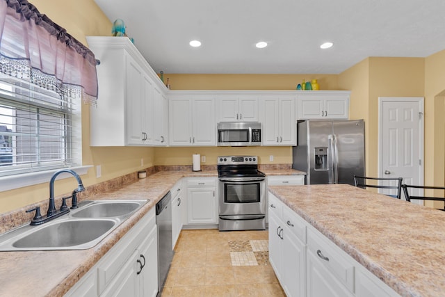 3044 Rockwell Ct, Graniteville, SC 29829 - kitchen with appliances with stainless steel finishes, white cabinetry, light countertops, recessed lighting, and light tile patterned flooring