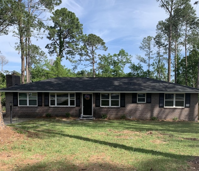 2312 Mura Dr, Augusta, GA 30906 - ranch-style home featuring brick siding, a chimney, and a front yard