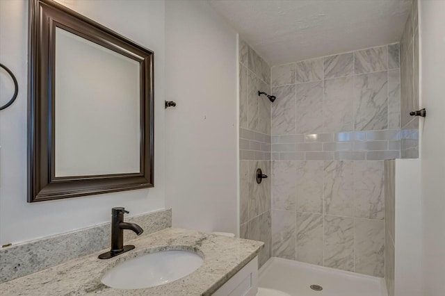 bathroom featuring toilet, vanity, and a shower stall