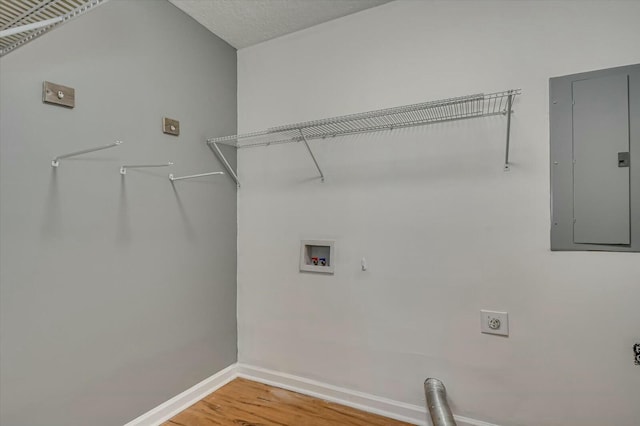 clothes washing area with laundry area, electric panel, baseboards, hookup for an electric dryer, and washer hookup