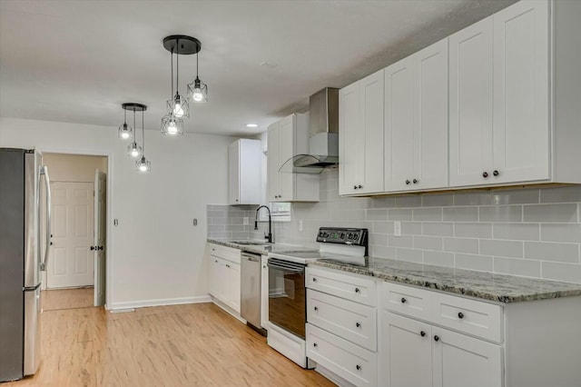 kitchen with wall chimney exhaust hood, white cabinetry, stainless steel appliances, and decorative light fixtures