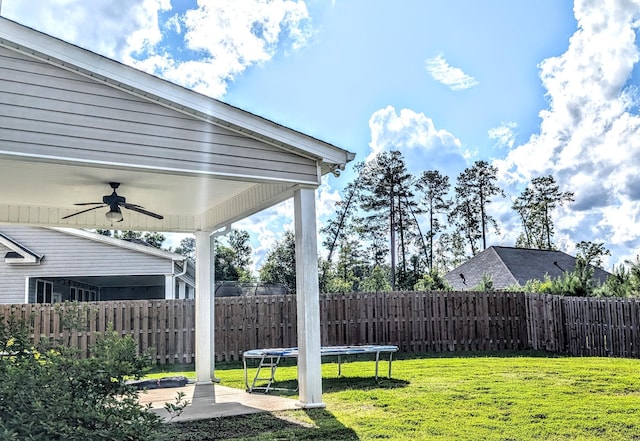 3113 Lobella Dr, Grovetown, GA 30813 - fenced backyard with ceiling fan, a trampoline, and a patio