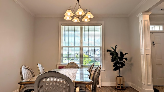3113 Lobella Dr, Grovetown, GA 30813 - dining area featuring a chandelier, dark wood-style flooring, ornamental molding, and ornate columns