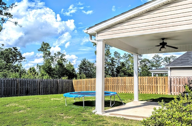 3113 Lobella Dr, Grovetown, GA 30813 - fenced backyard with a trampoline, a ceiling fan, and a patio