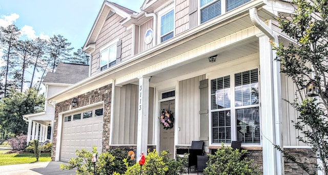 3113 Lobella Dr, Grovetown, GA 30813 - entrance to property with a porch, driveway, stone siding, an attached garage, and board and batten siding