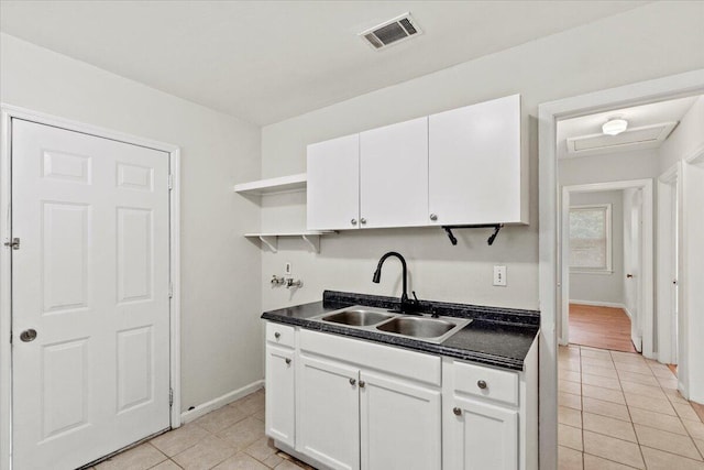 2436 Juniper Dr, Augusta, GA 30906 - kitchen with a sink, open shelves, light tile patterned floors, and dark countertops