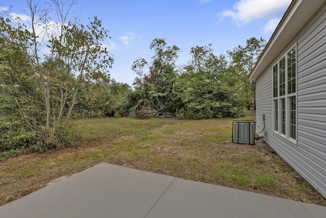 view of yard featuring cooling unit and a patio area