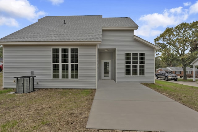 exterior space with central AC and a yard