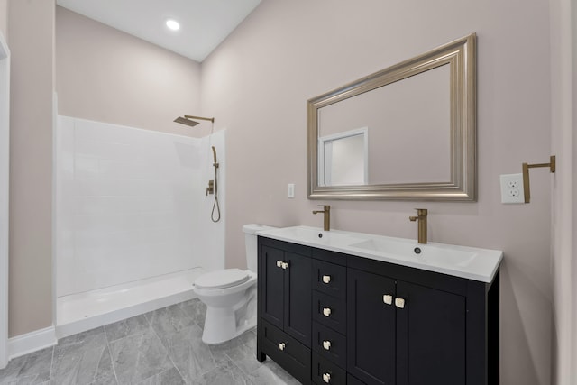 bathroom featuring vanity, toilet, and walk in shower