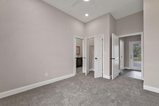 unfurnished bedroom featuring carpet flooring, ceiling fan, and a closet