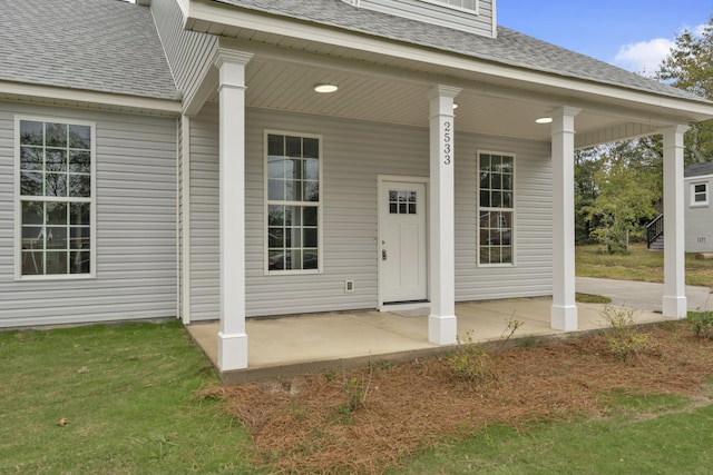 view of exterior entry with covered porch