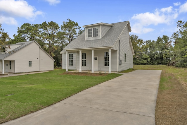 cape cod home with a front yard and covered porch