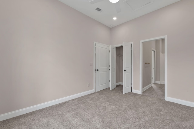 unfurnished bedroom featuring light carpet and ceiling fan